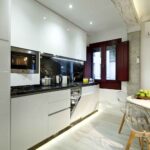 open kitchen with dishwasher and washing machine in new apartment for rent near alhambra spain