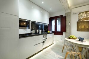 open kitchen with dishwasher and washing machine in new apartment for rent near alhambra spain