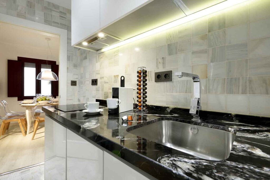 modern integrated kitchen in cozy short term apartment rental in the albaicin quarter, granada